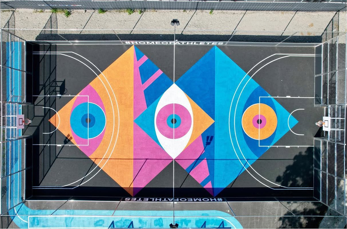 Aerial view of a basketball court painted by SuperBlast with colorful geometric eye motifs, Sports Base Berlin, 2018